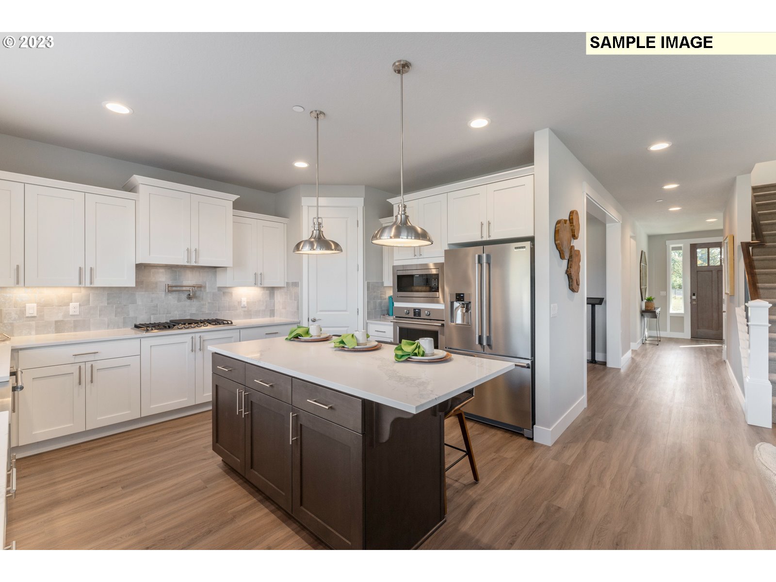 5597 North 94th Avenue, Unit LT246 Camas, WA 98607 - Photo 11 of 32 a kitchen with a refrigerator a sink dishwasher and a stove with wooden floor