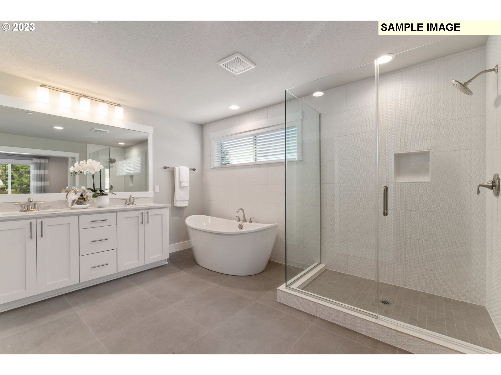 5597 North 94th Avenue, Unit LT246 Camas, WA 98607 - Photo 16 of 32 a spacious bathroom with a double vanity sink a large mirror and shower