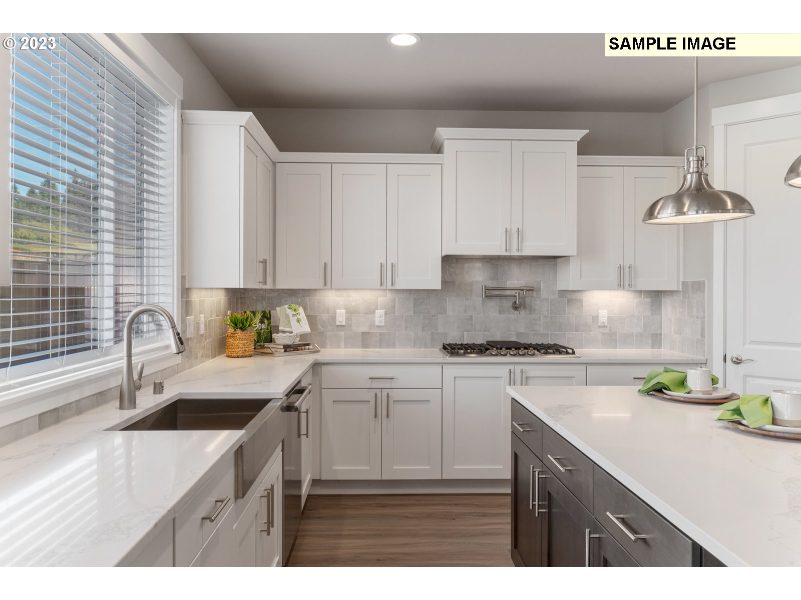 5597 North 94th Avenue, Unit LT246 Camas, WA 98607 - Photo 8 of 32 a kitchen with kitchen island granite countertop a sink a stove a counter space and cabinets