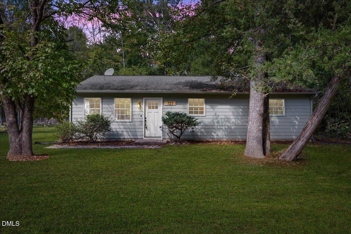 a front view of a house with a garden