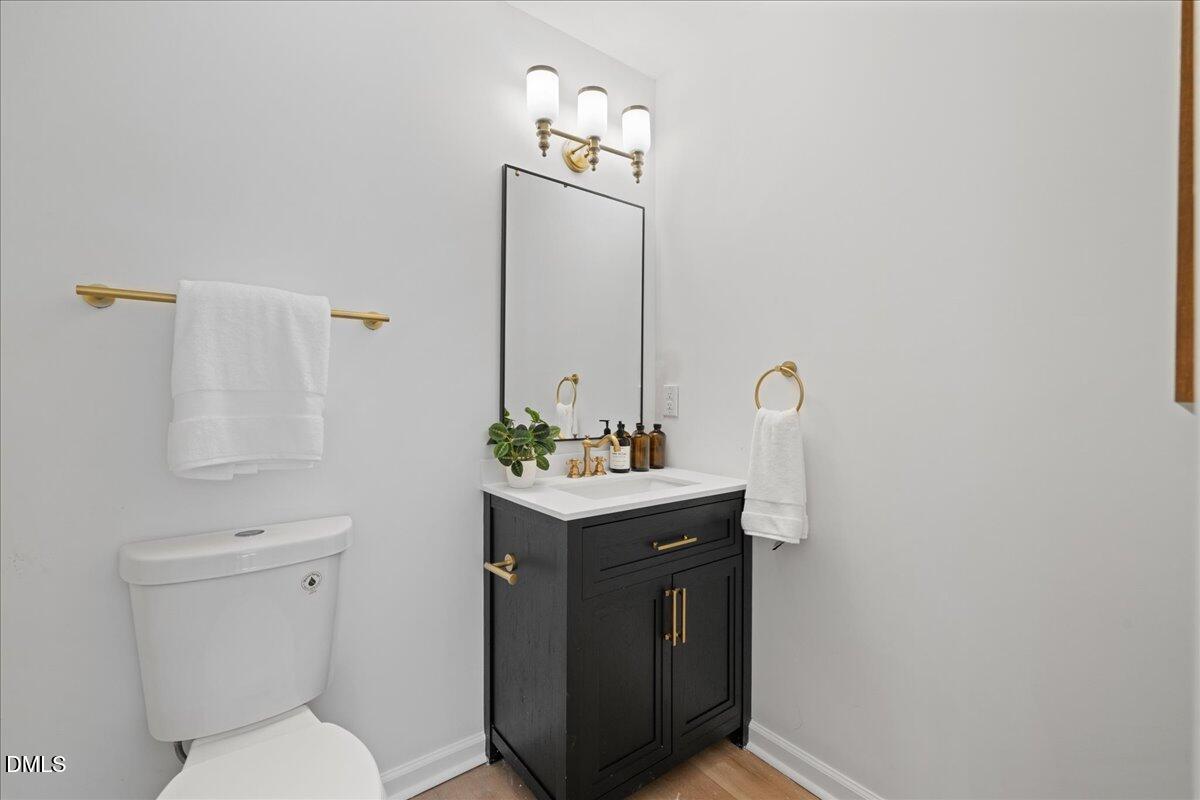 809 Felicia Street Durham, NC 27704 - Photo 16 of 31 a bathroom with a toilet sink and mirror