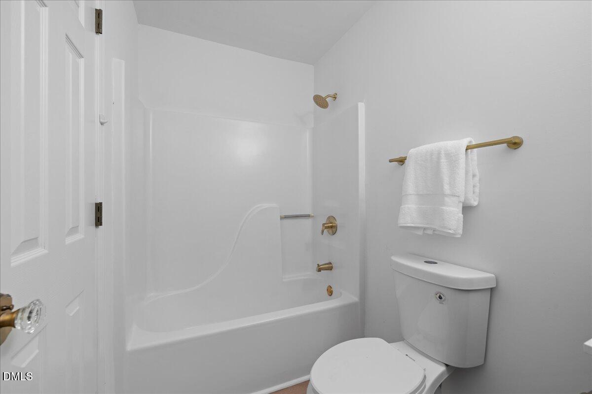 809 Felicia Street Durham, NC 27704 - Photo 17 of 31 a bathroom with a toilet a sink and bathtub