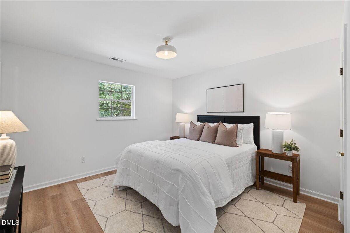 809 Felicia Street Durham, NC 27704 - Photo 20 of 31 a bedroom with a bed and a window