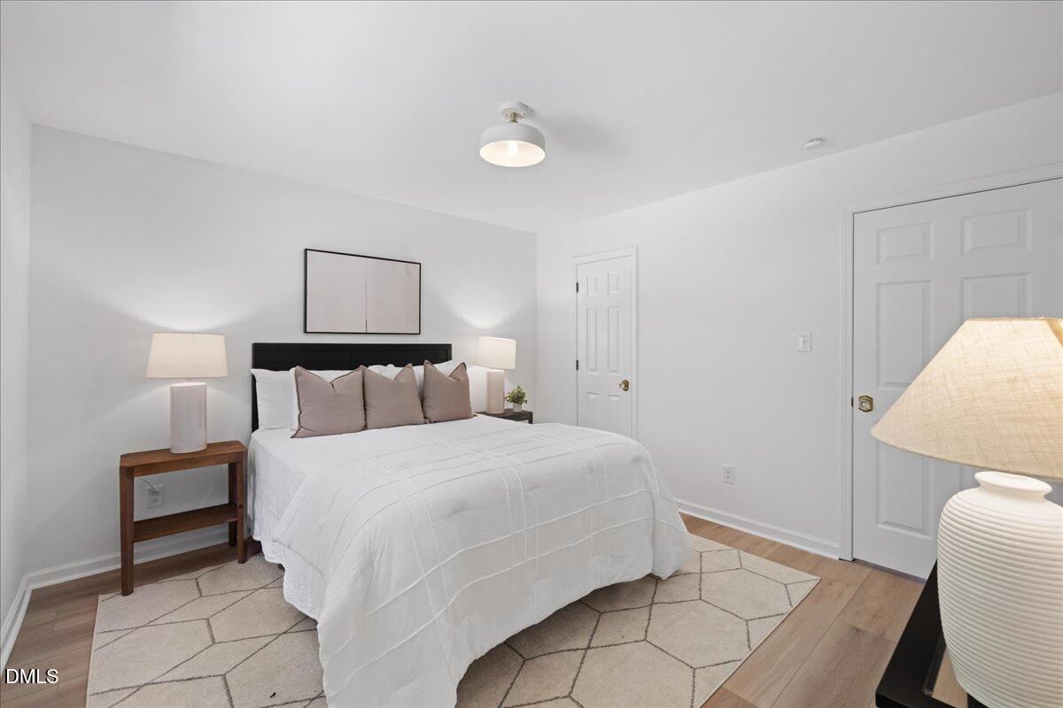 809 Felicia Street Durham, NC 27704 - Photo 21 of 31 a bedroom with a bed and a chair