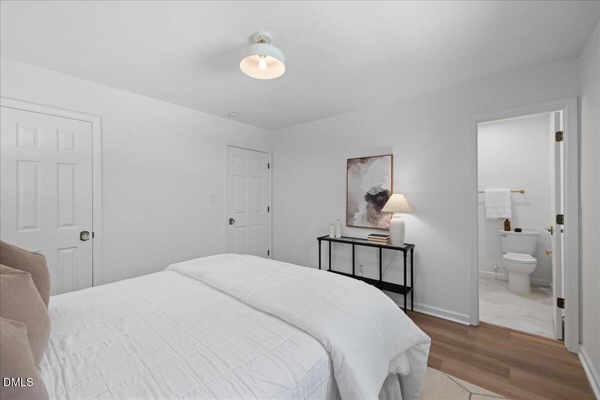 809 Felicia Street Durham, NC 27704 - Photo 22 of 31 a bedroom with a bed and a chandelier