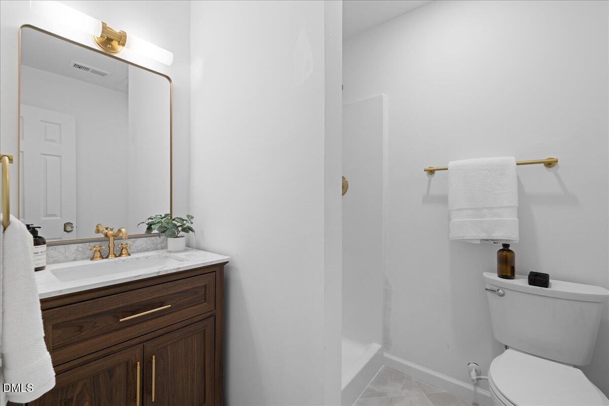 809 Felicia Street Durham, NC 27704 - Photo 23 of 31 a bathroom with a sink a toilet and a mirror