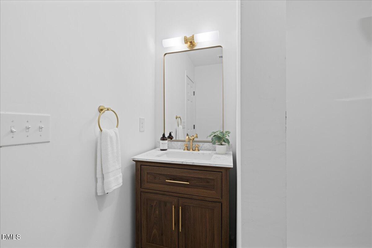 809 Felicia Street Durham, NC 27704 - Photo 25 of 31 a bathroom with a sink a toilet and mirror