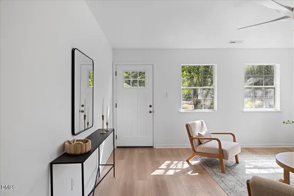 a living room with furniture and kitchen view