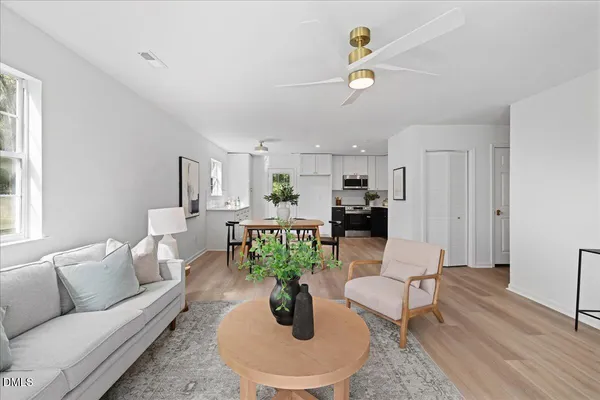 a living room with furniture and wooden floor