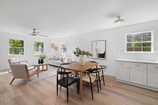 a view of a dining room with furniture and wooden floor