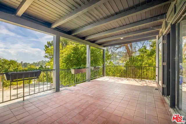 a view of porch with a floor to ceiling window and wooden fence