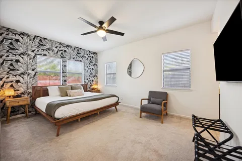 a bedroom with a bed and a flat screen tv