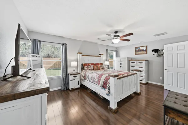 a spacious bathroom with a bathtub shower sink mirror and toilet