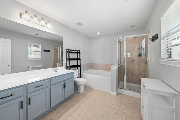 a bedroom with furniture and a window