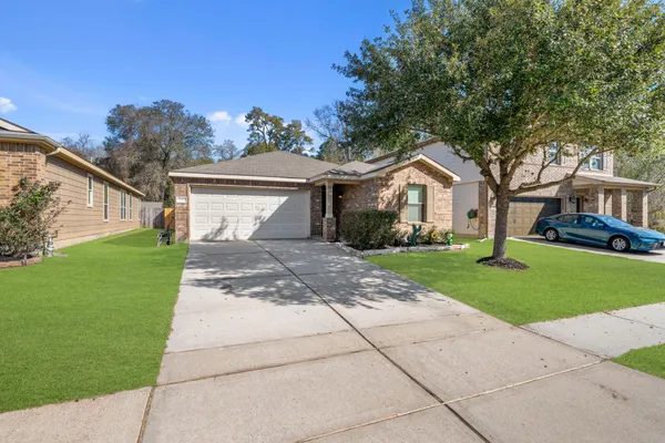 a front view of a house with a garden and yard