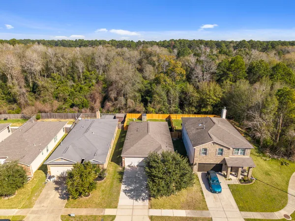 an aerial view of residential houses with outdoor space