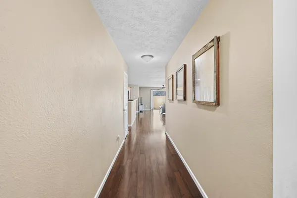 a living room with furniture a large window and wooden floor