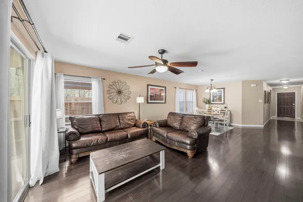 a living room with furniture and wooden floor