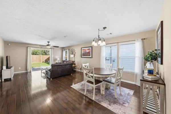 a dining room with furniture window and wooden floor