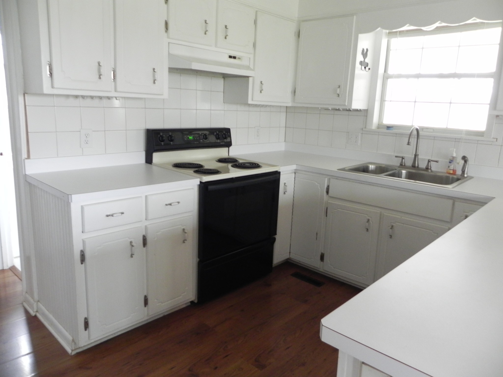 444 Nixon Road Red Boiling Springs, TN 37150 - Photo 11 of 41 a kitchen with cabinets appliances a sink and a window
