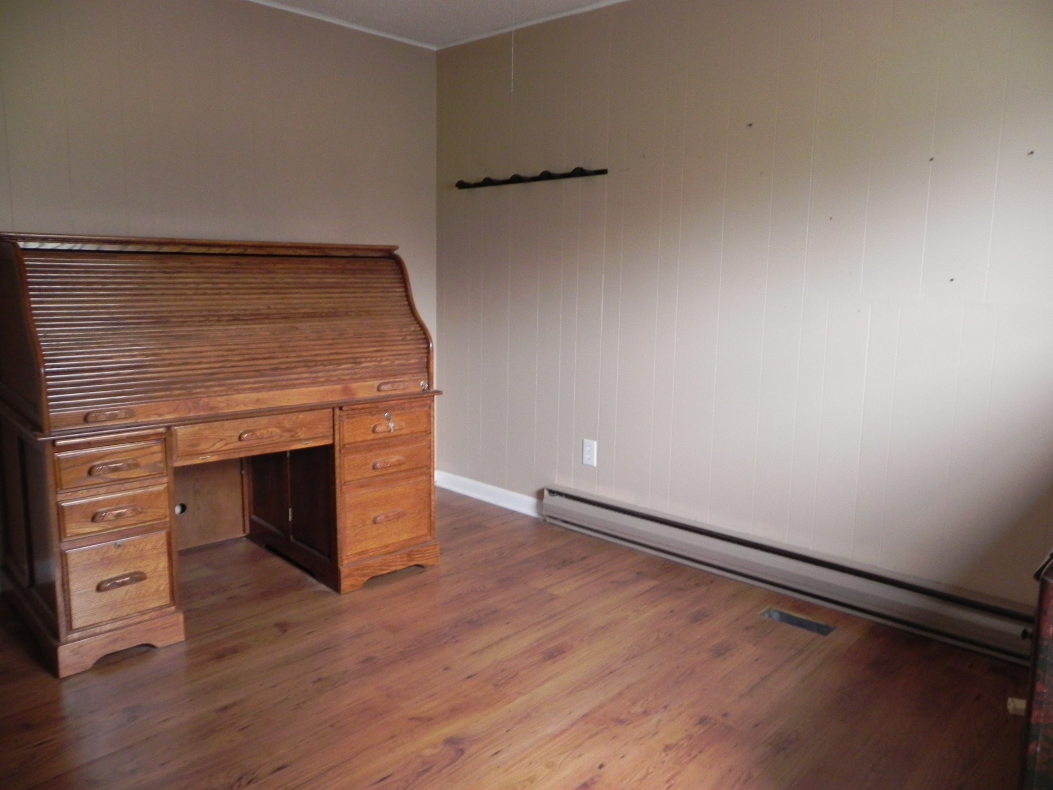 444 Nixon Road Red Boiling Springs, TN 37150 - Photo 16 of 41 a view of an empty room with wooden floor and a fireplace