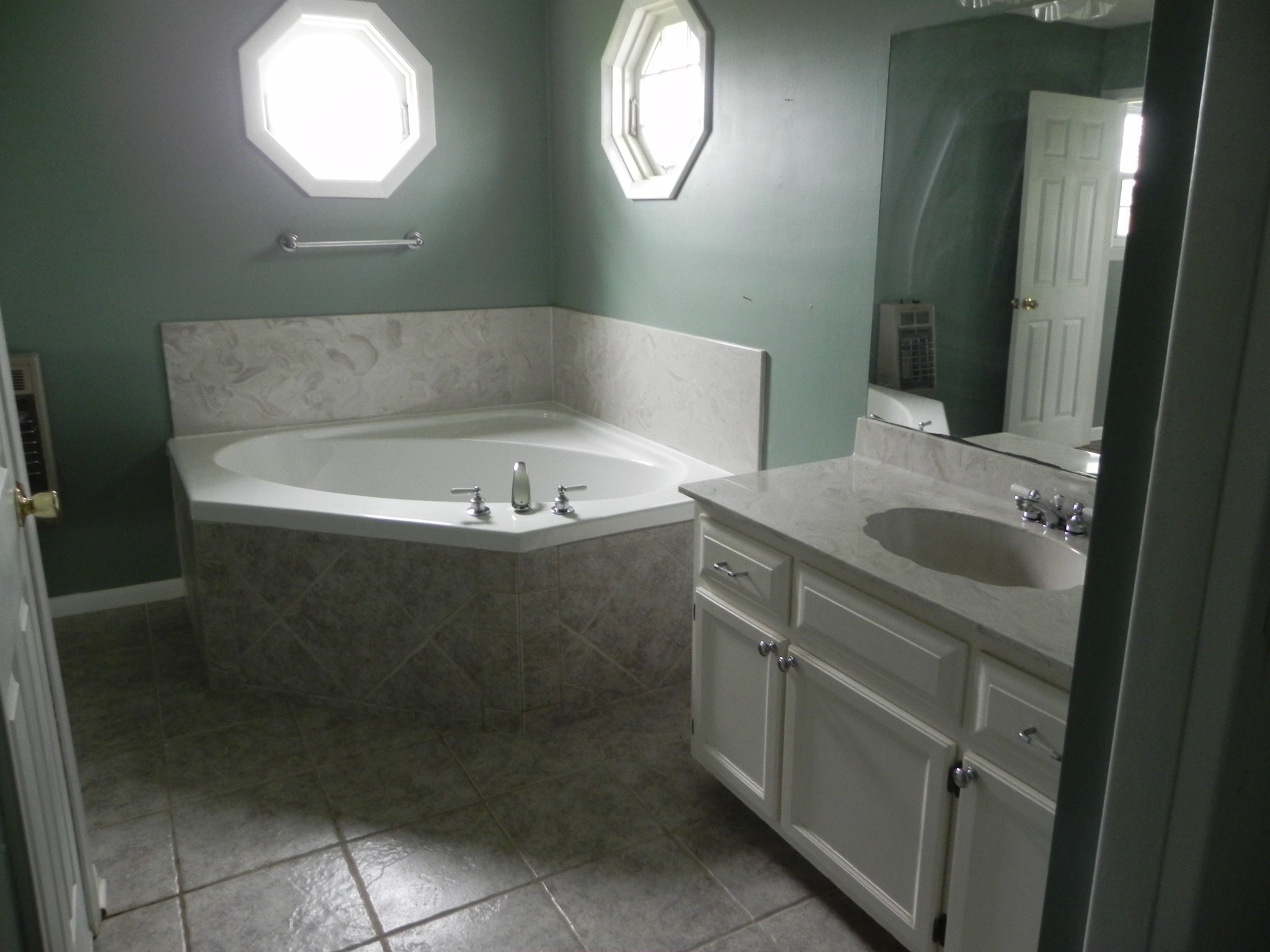 444 Nixon Road Red Boiling Springs, TN 37150 - Photo 24 of 41 a bathroom with a bathtub sink and mirror