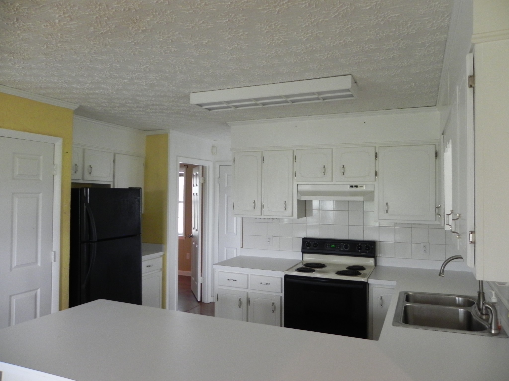 444 Nixon Road Red Boiling Springs, TN 37150 - Photo 10 of 41 a kitchen with stainless steel appliances a refrigerator stove and sink