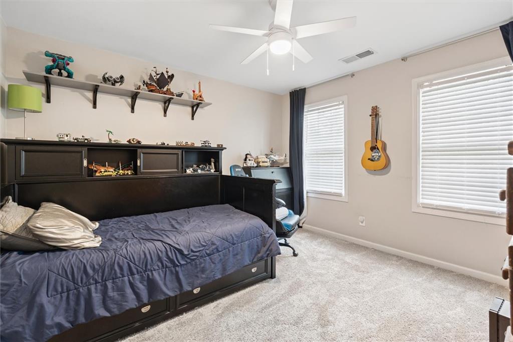 326 Senators Ridge Drive Dallas, GA 30132 - Photo 26 of 37 a bedroom with a bed and wooden floor