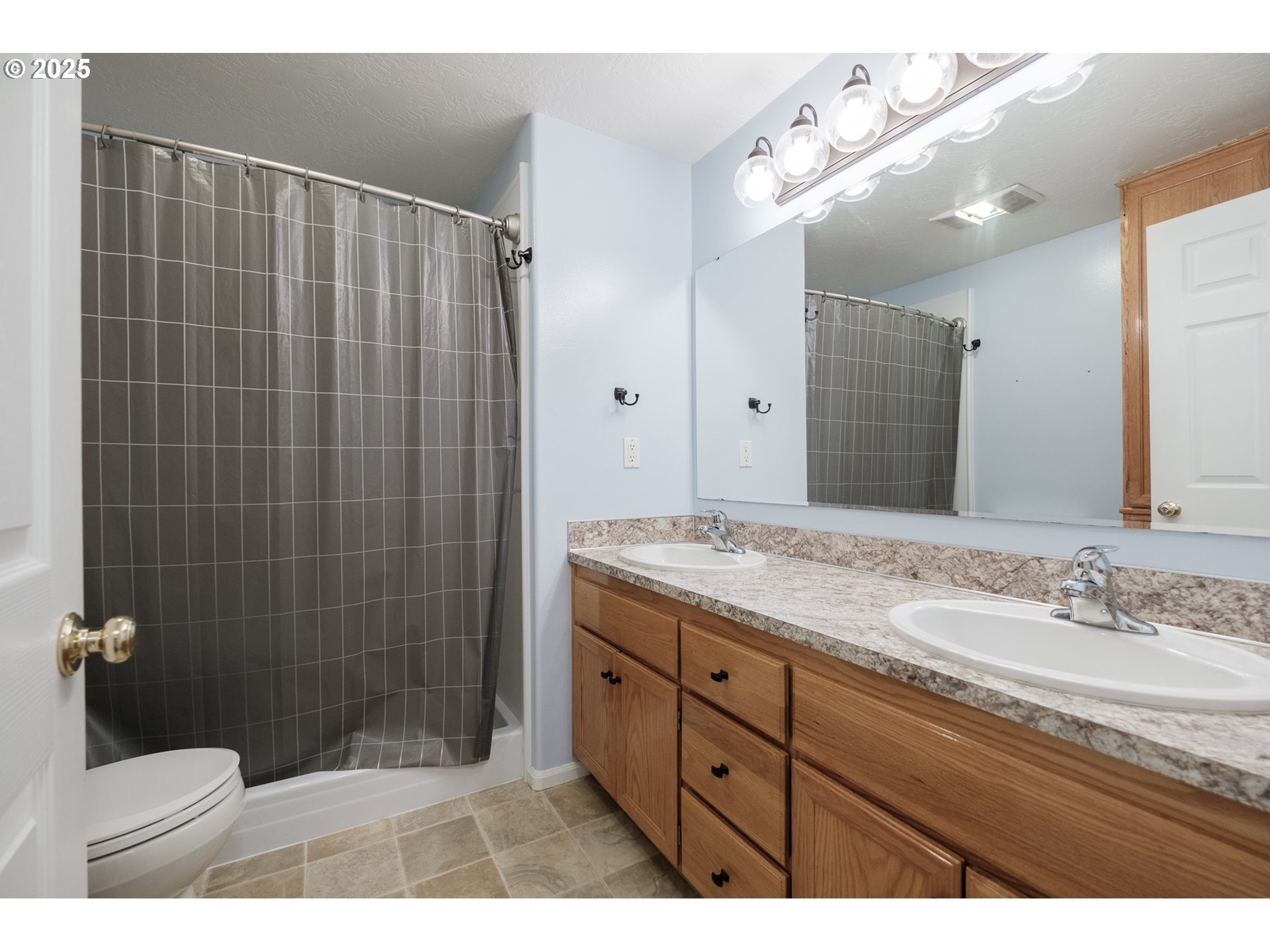 1548 Fetters Loop Eugene, OR 97402 - Photo 21 of 33 a bathroom with a granite countertop sink a toilet a mirror and shower