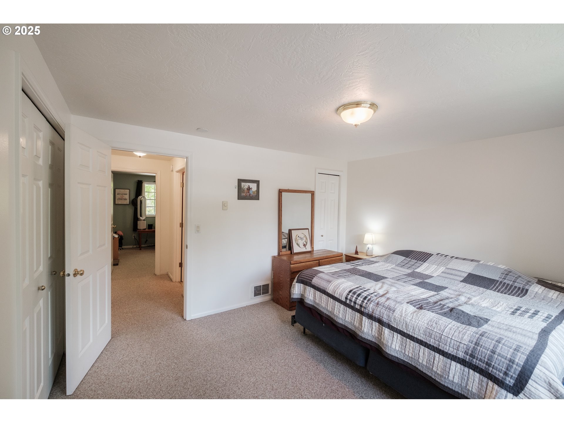 1548 Fetters Loop Eugene, OR 97402 - Photo 25 of 33 a bedroom with a bed and a lamp