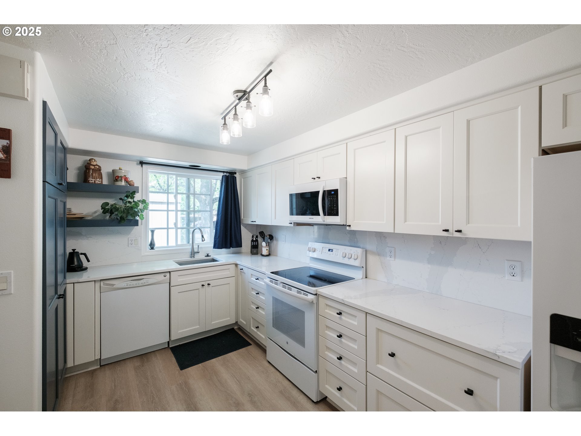 1548 Fetters Loop Eugene, OR 97402 - Photo 6 of 33 a kitchen with stainless steel appliances a sink a stove and cabinets