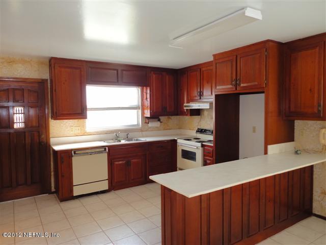 284 Barrataria Drive St. Augustine, FL 32080 - Photo 6 of 24 a kitchen with stainless steel appliances a refrigerator sink and cabinets