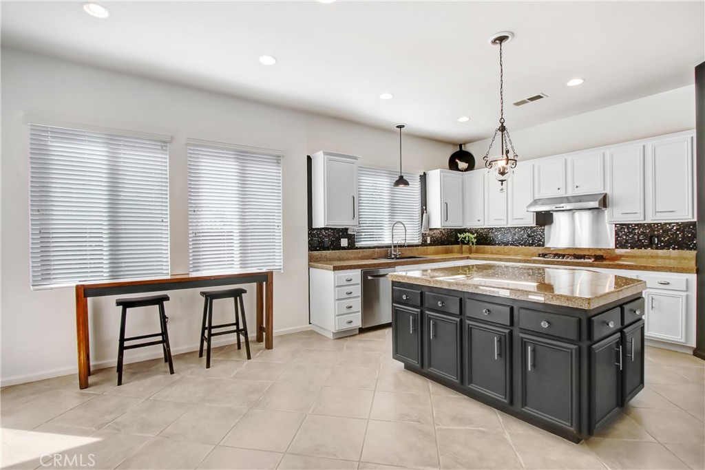 36109 Eagle Lane Beaumont, CA 92223 - Photo 13 of 42 a kitchen with stainless steel appliances granite countertop a stove a sink a oven and a refrigerator