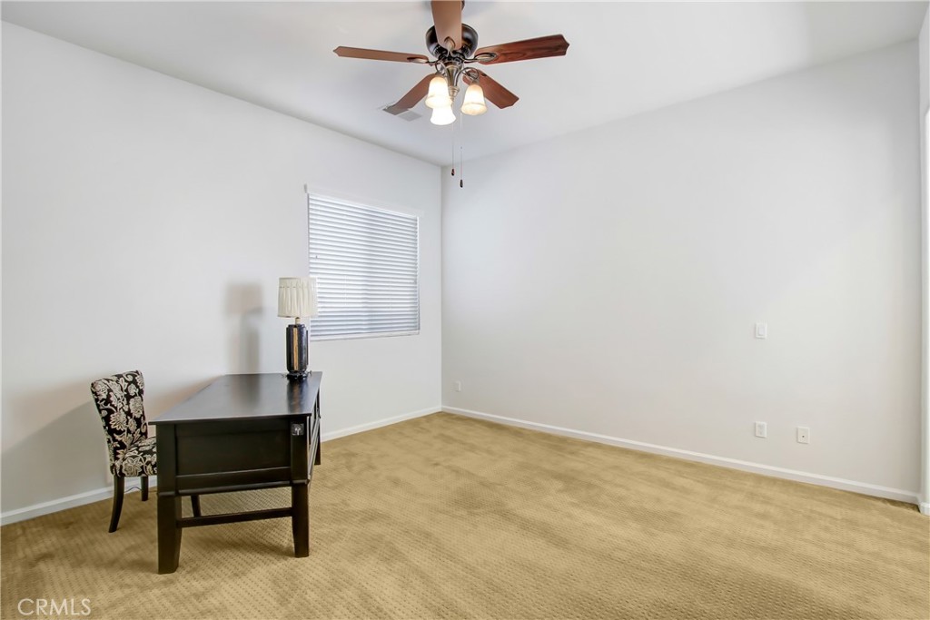 36109 Eagle Lane Beaumont, CA 92223 - Photo 19 of 42 a workspace room with furniture and a chandelier fan