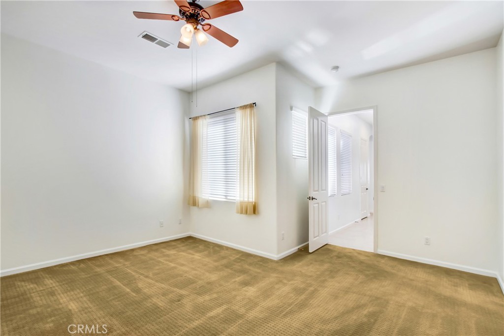36109 Eagle Lane Beaumont, CA 92223 - Photo 21 of 42 an empty room with fan and windows