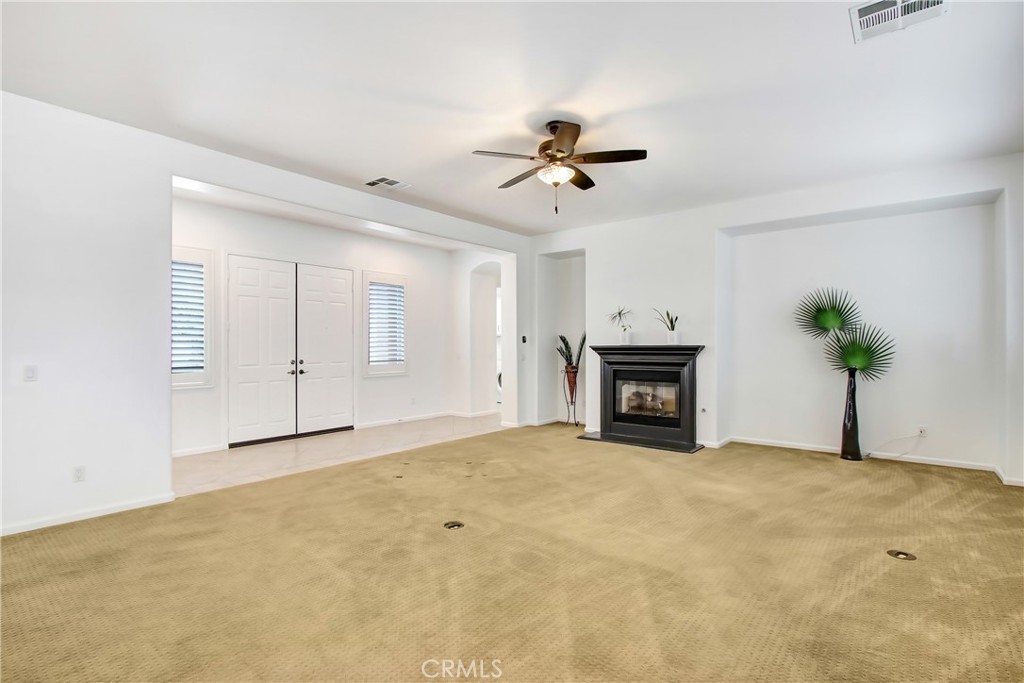 36109 Eagle Lane Beaumont, CA 92223 - Photo 6 of 42 a view of an empty room with a fireplace and a window