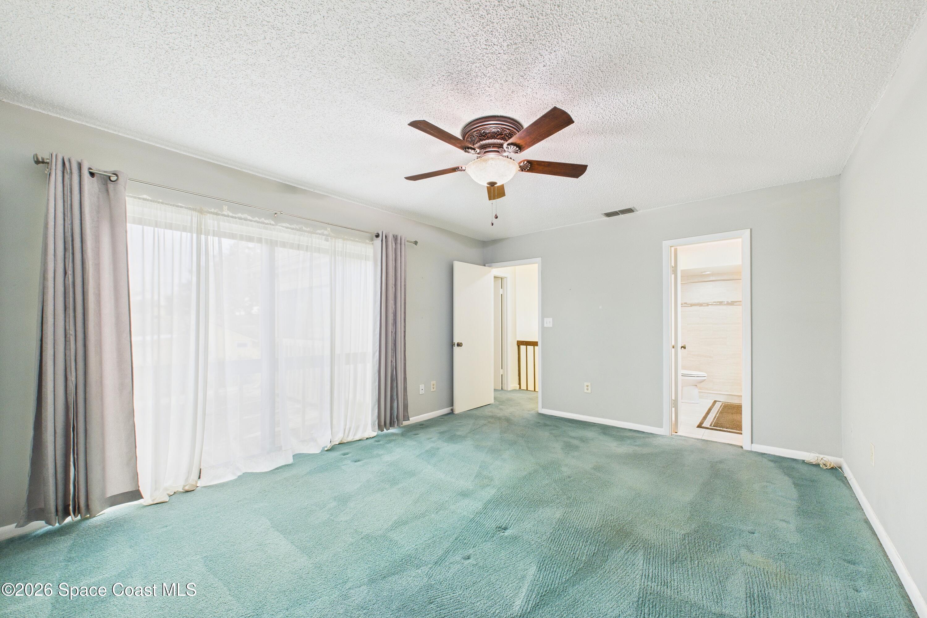 204 Country Club Drive Melbourne, FL 32940 - Photo 14 of 63 a view of room with a ceiling fan and hardwood floor