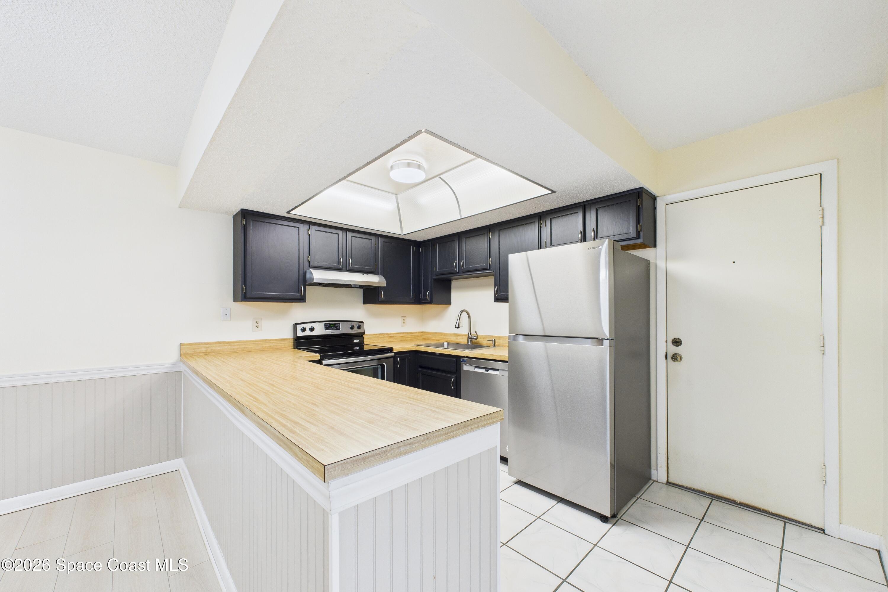 204 Country Club Drive Melbourne, FL 32940 - Photo 2 of 63 a kitchen with a refrigerator sink and microwave