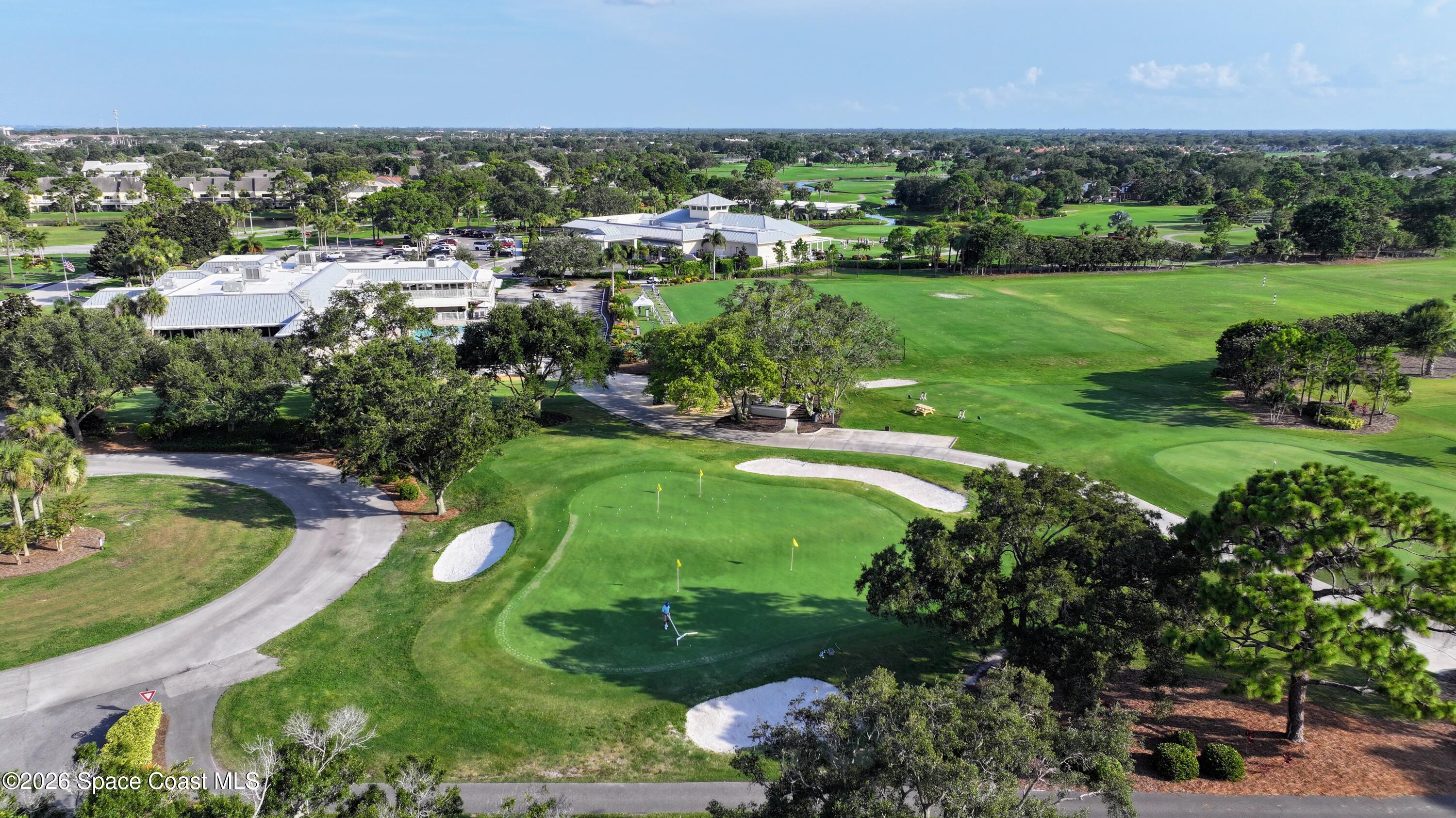 204 Country Club Drive Melbourne, FL 32940 - Photo 29 of 63 an aerial view of a houses with outdoor space and trees all around