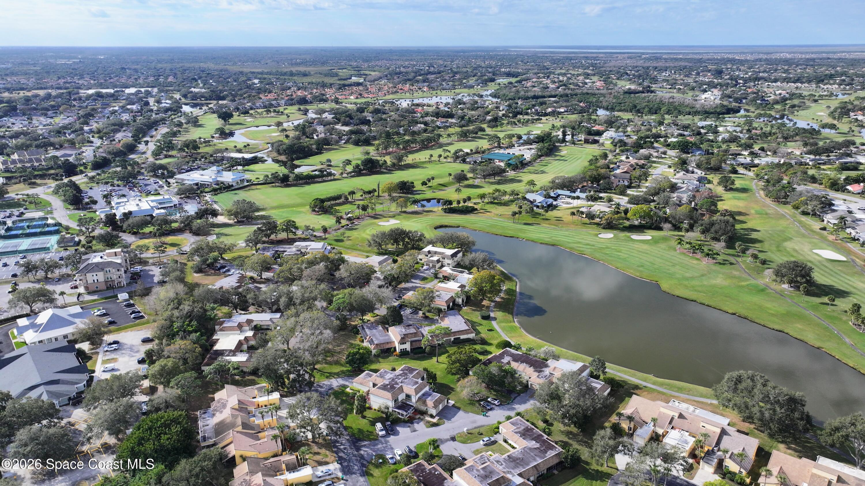 204 Country Club Drive Melbourne, FL 32940 - Photo 33 of 63 an aerial view of a houses with a lake