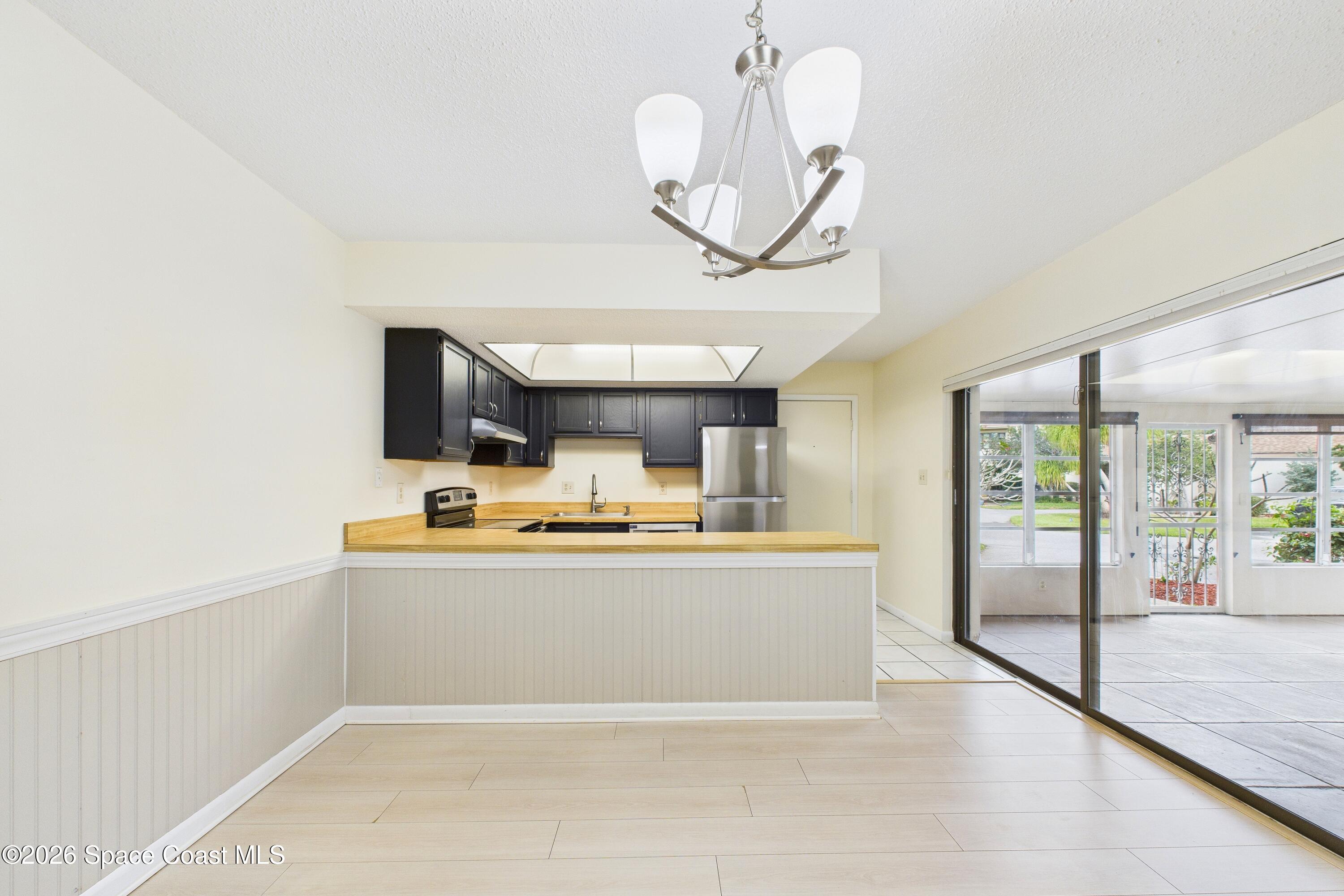 204 Country Club Drive Melbourne, FL 32940 - Photo 50 of 63 a view of living room with granite countertop furniture a fireplace and a chandelier