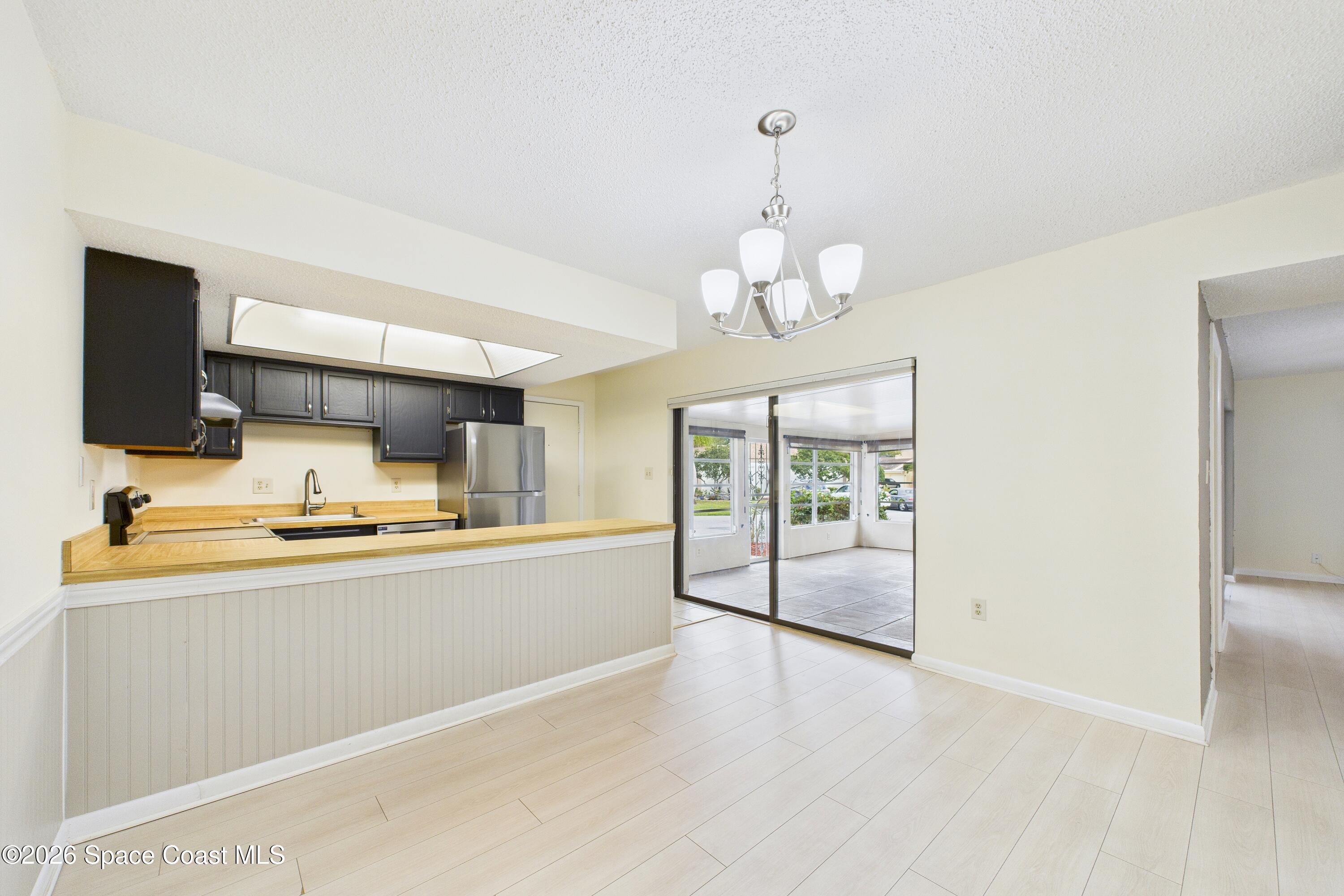 204 Country Club Drive Melbourne, FL 32940 - Photo 51 of 63 a large kitchen with kitchen island stainless steel appliances microwave and stove top oven