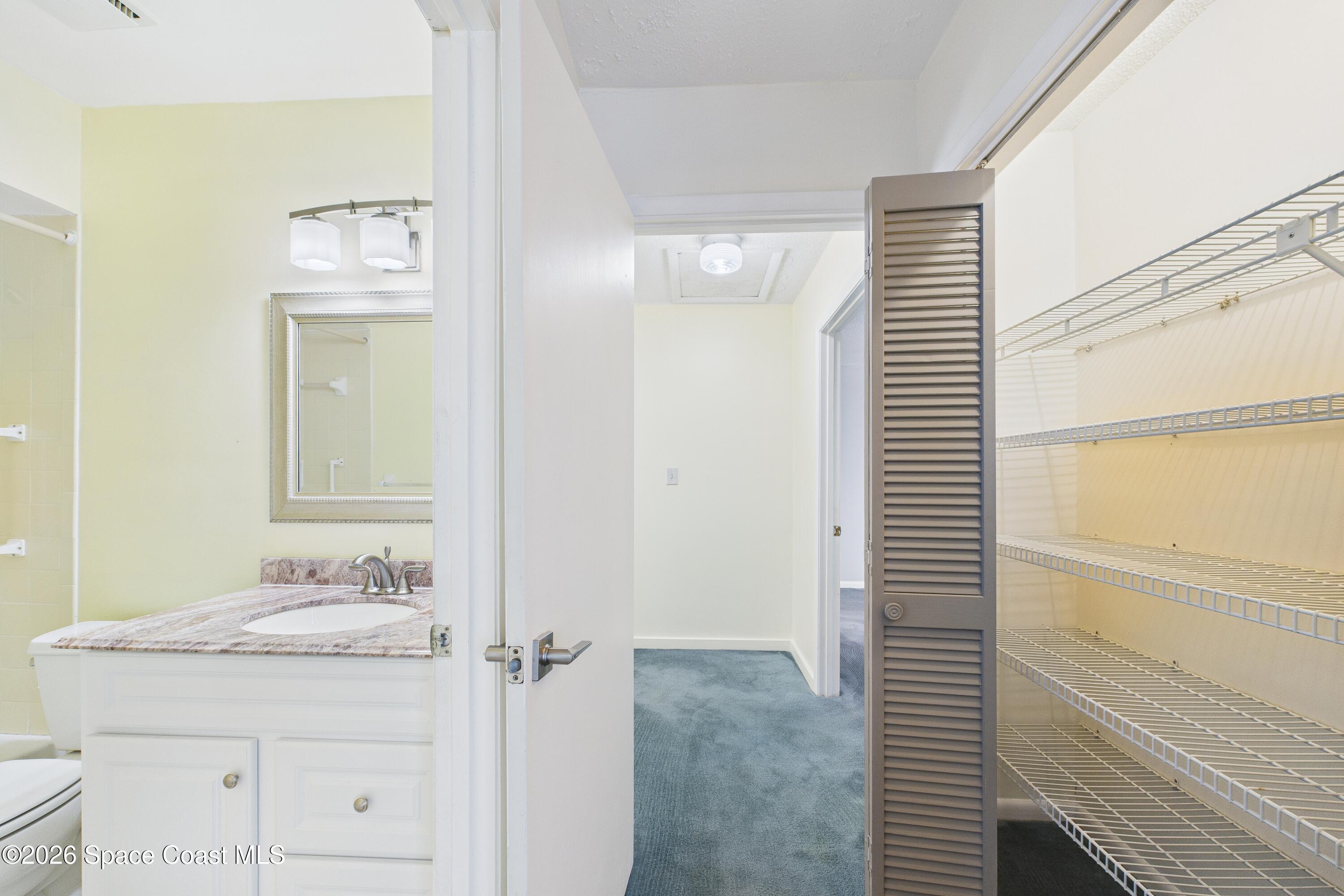 204 Country Club Drive Melbourne, FL 32940 - Photo 58 of 63 a bathroom with a granite countertop sink and a mirror