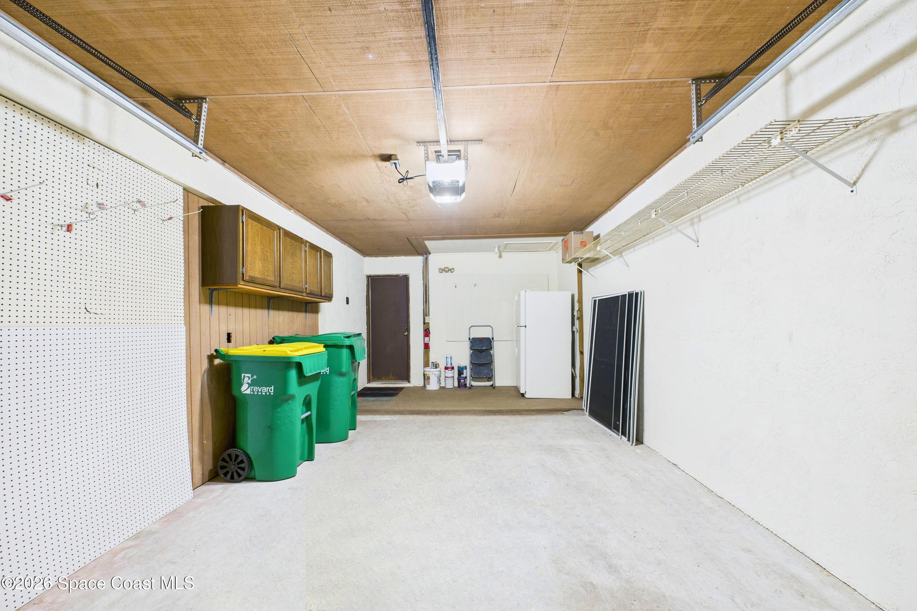 204 Country Club Drive Melbourne, FL 32940 - Photo 60 of 63 a view of a hallway with a yellow plant