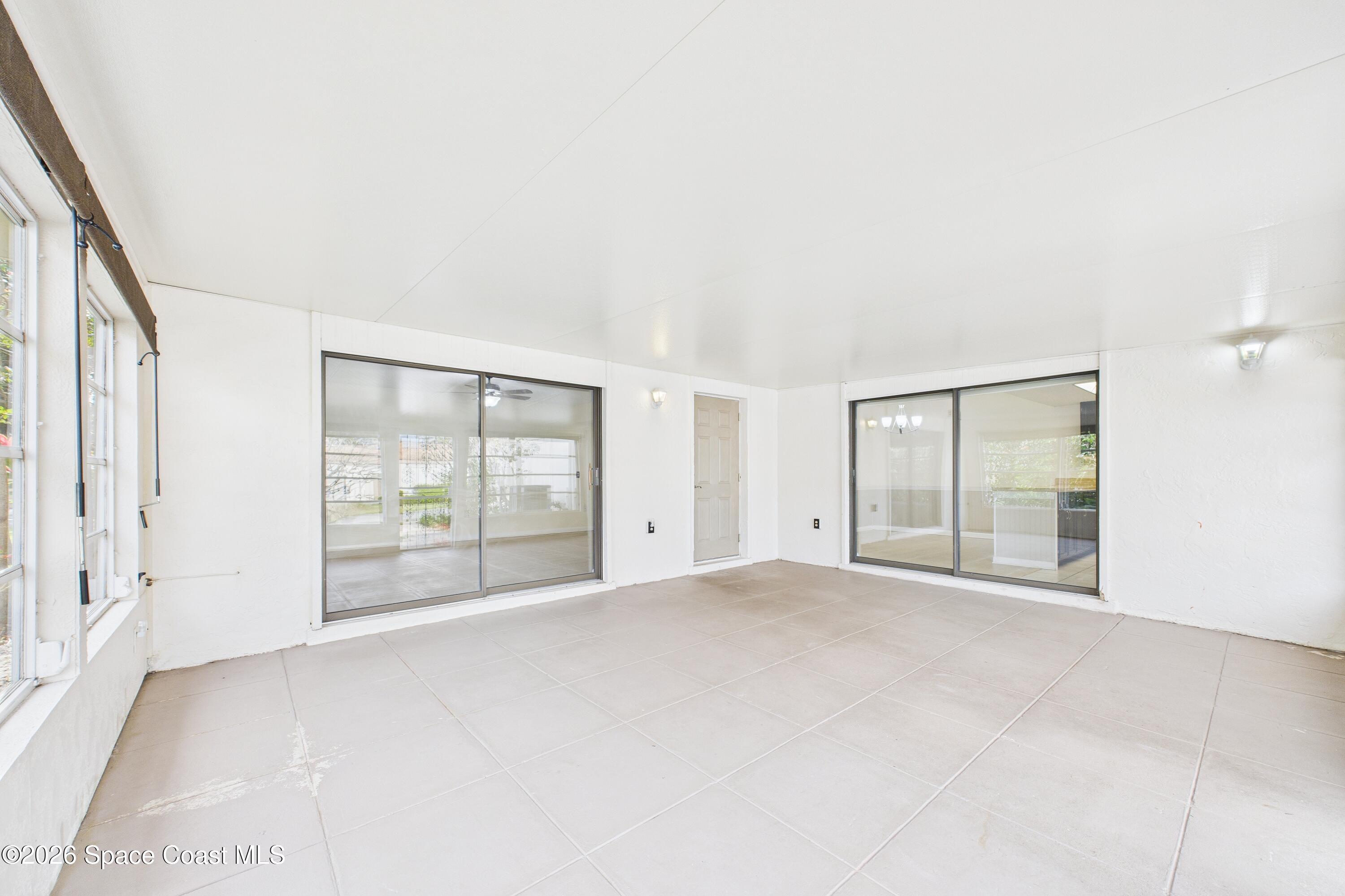 204 Country Club Drive Melbourne, FL 32940 - Photo 9 of 63 an empty room with large windows