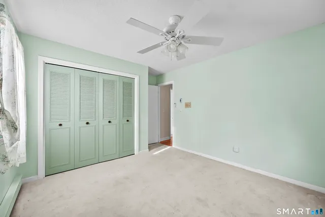 a bathroom with a granite countertop toilet sink and mirror