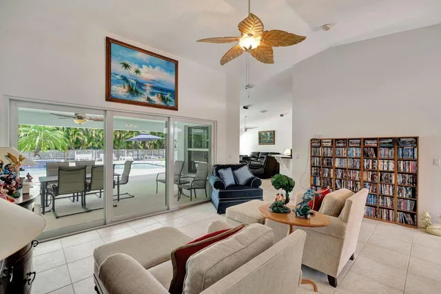 a living room with furniture a chandelier and a large window