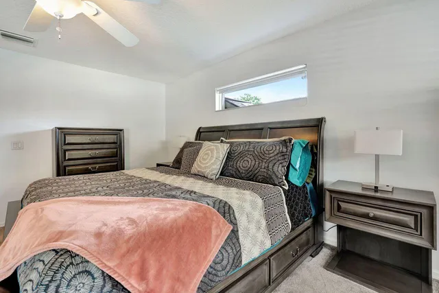 a bedroom with bed and wooden floor