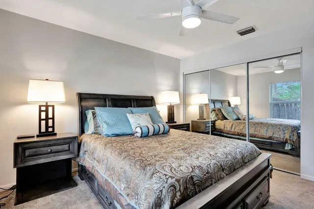 a bedroom with bed and a chandelier