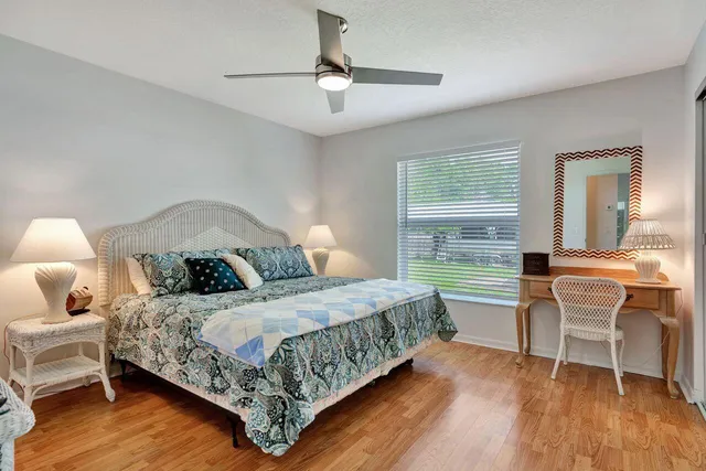 a bedroom with a bed a table and chair